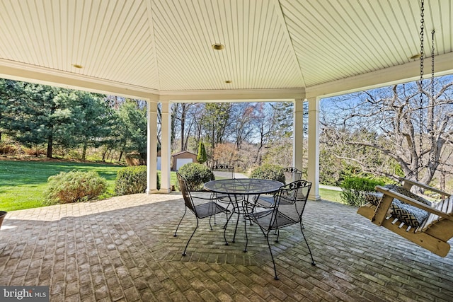 view of patio with an outbuilding and outdoor dining space