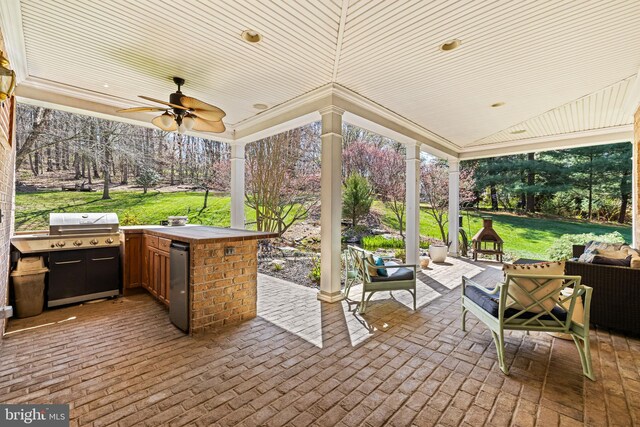 view of patio with an outdoor living space, a ceiling fan, and area for grilling