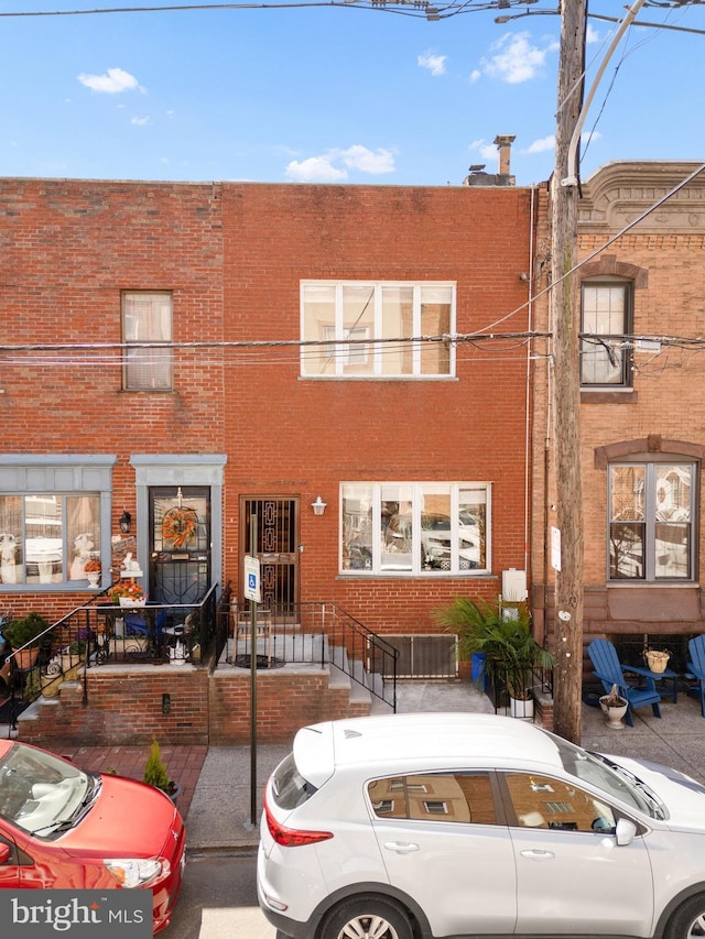 townhome / multi-family property featuring brick siding