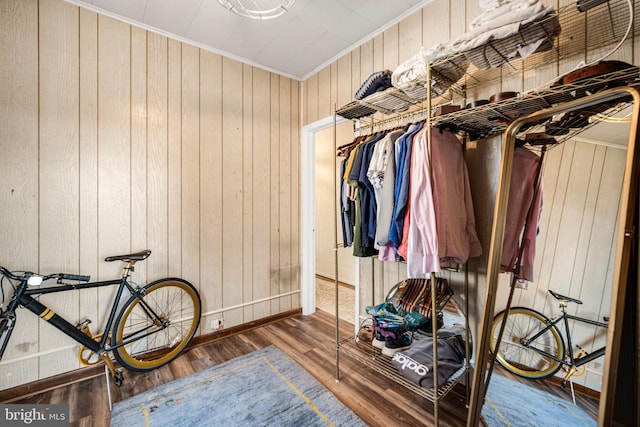 walk in closet with wood finished floors