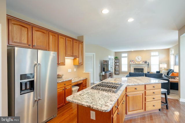 869 Bourban Ln, West Grove, PA 19390 - kitchen with stainless steel appliances, a kitchen island, light wood-style flooring, a fireplace, and recessed lighting