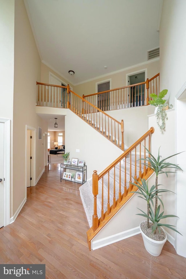 869 Bourban Ln, West Grove, PA 19390 - staircase with high vaulted ceiling, wood finished floors, and crown molding