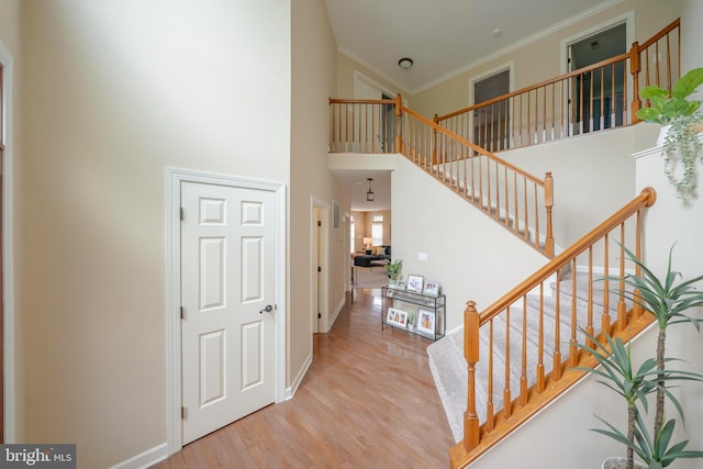 869 Bourban Ln, West Grove, PA 19390 - stairs featuring a high ceiling, wood finished floors, and ornamental molding