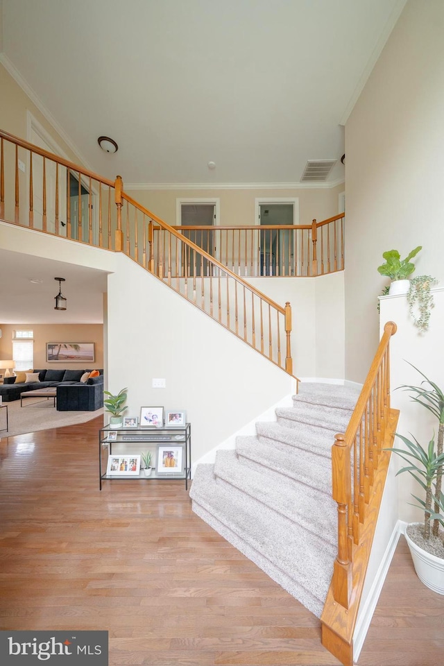 869 Bourban Ln, West Grove, PA 19390 - staircase featuring wood finished floors and crown molding