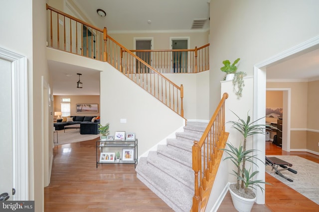 869 Bourban Ln, West Grove, PA 19390 - stairway with wood finished floors, crown molding, and a towering ceiling