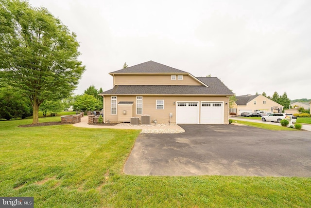 869 Bourban Ln, West Grove, PA 19390 - back of house with asphalt driveway, a yard, and an attached garage