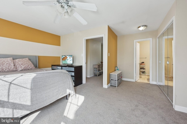bedroom featuring ensuite bath, ceiling fan, light carpet, and baseboards