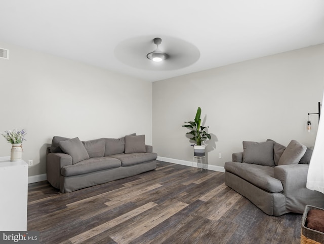 living room with visible vents, baseboards, a ceiling fan, and dark wood-style floors