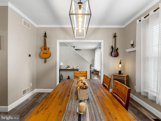 dining space featuring crown molding, wood finished floors, and visible vents