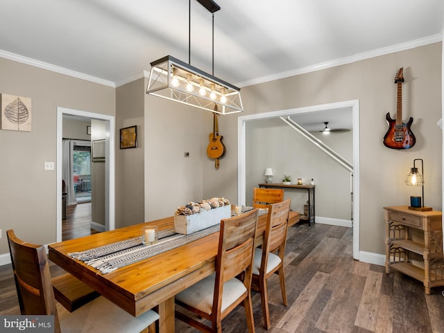 dining room with dark wood-type flooring, baseboards, crown molding, and ceiling fan with notable chandelier