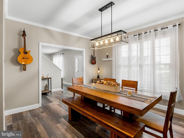 dining area featuring ornamental molding, baseboards, and dark wood-style floors