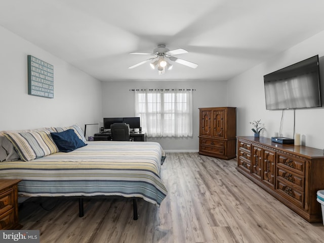 bedroom with light wood-type flooring, baseboards, and a ceiling fan