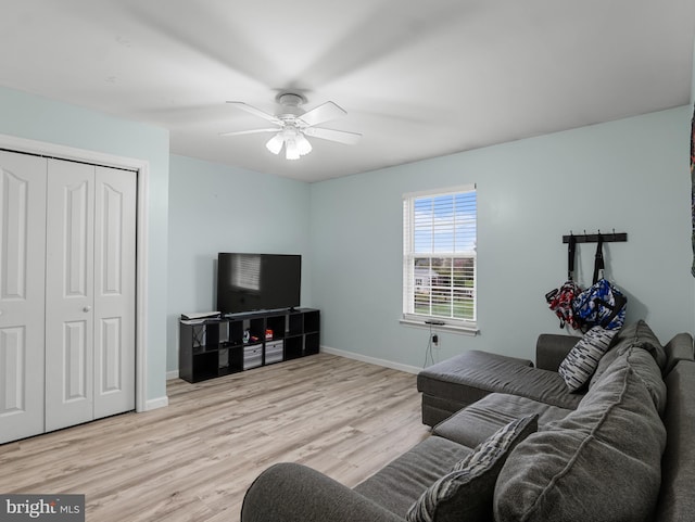 living room with ceiling fan, wood finished floors, and baseboards
