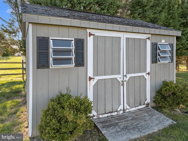 view of shed with fence
