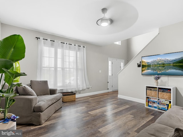 living room with baseboards and wood finished floors