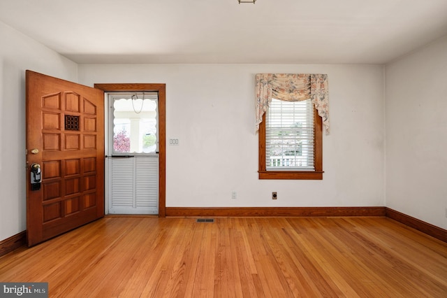 entrance foyer featuring light wood-type flooring, baseboards, and visible vents