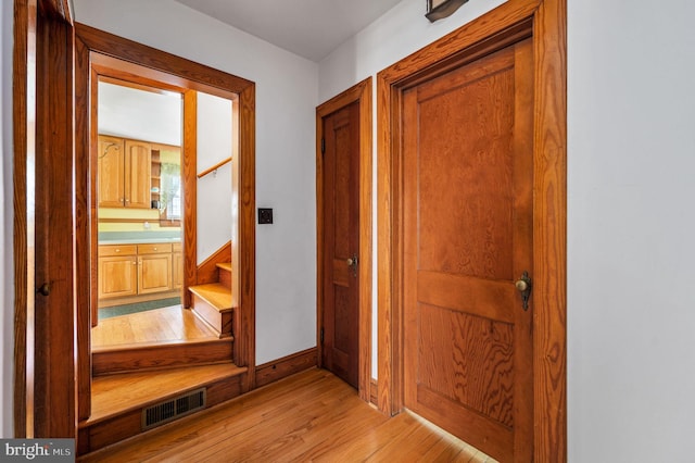 interior space with stairway, visible vents, and light wood finished floors