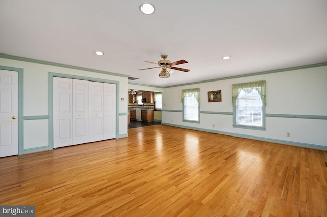 unfurnished bedroom featuring baseboards, crown molding, light wood finished floors, and recessed lighting