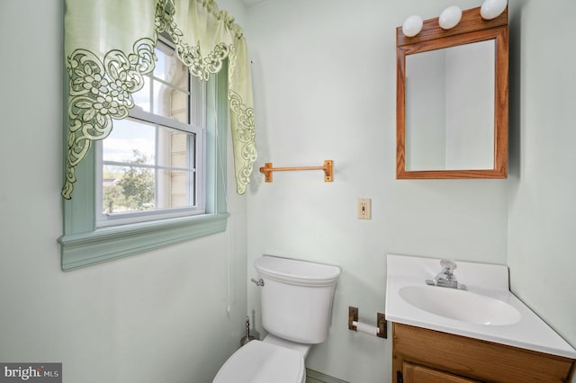 half bath featuring toilet and vanity