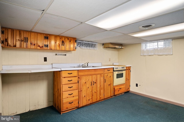 kitchen featuring dark carpet, brown cabinets, visible vents, and light countertops