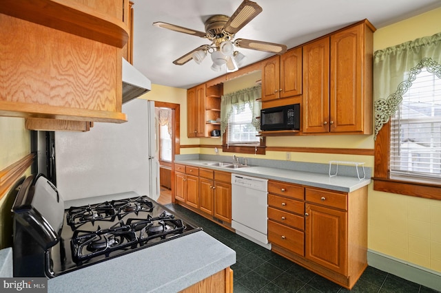kitchen featuring light countertops, open shelves, a ceiling fan, a sink, and black appliances