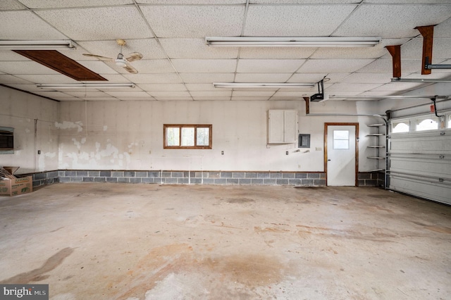 garage with electric panel and a garage door opener