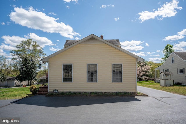 view of property exterior with driveway