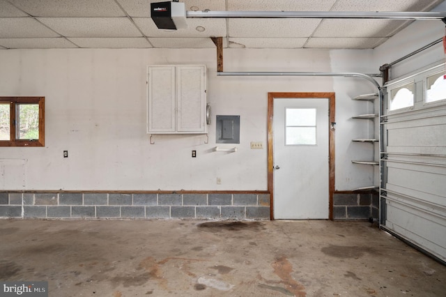 garage with electric panel and a garage door opener