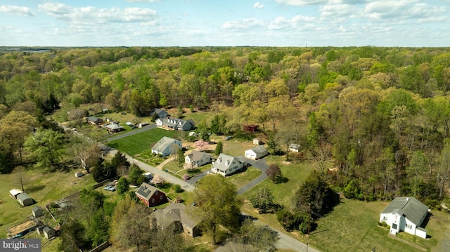 drone / aerial view with a wooded view