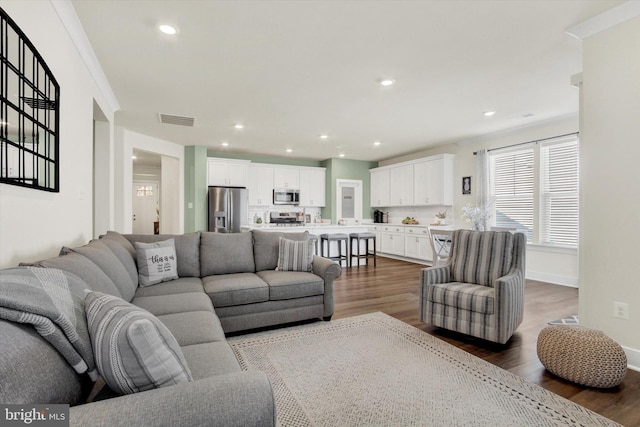 living room with recessed lighting, visible vents, baseboards, and dark wood-style floors