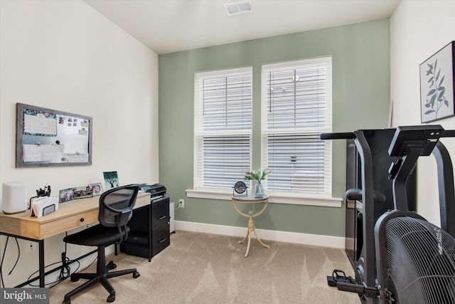 home office featuring light carpet, visible vents, and baseboards
