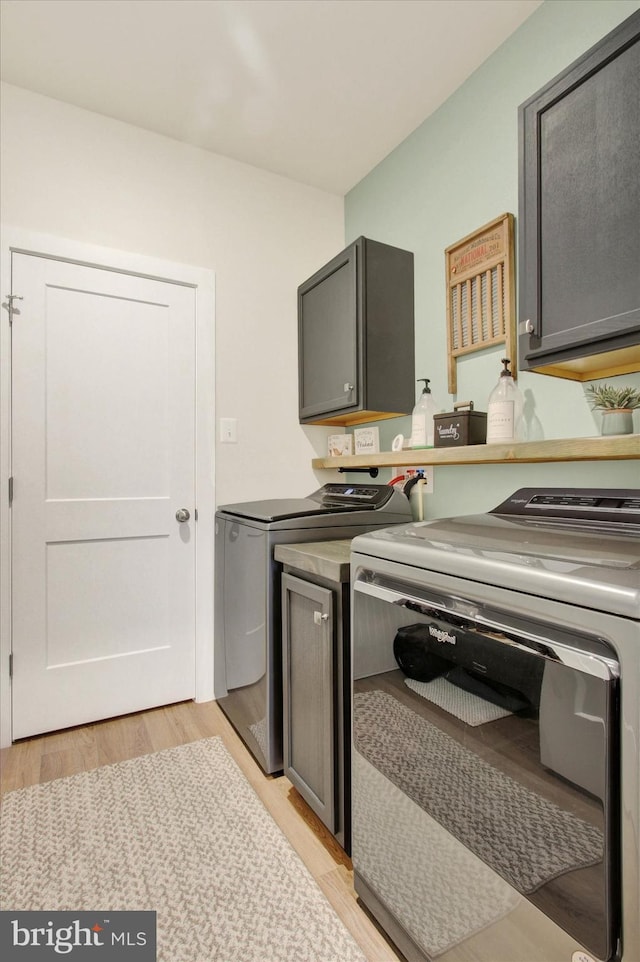 kitchen with light wood-type flooring and independent washer and dryer