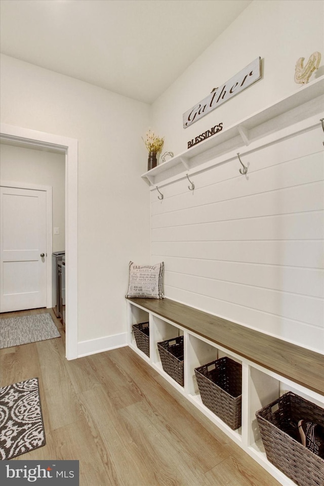 mudroom with baseboards and wood finished floors