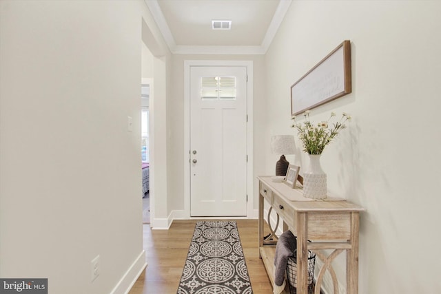 entrance foyer with visible vents, a wealth of natural light, light wood finished floors, and baseboards