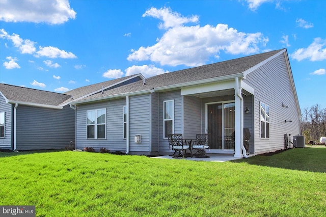rear view of house featuring central AC, a patio, and a lawn