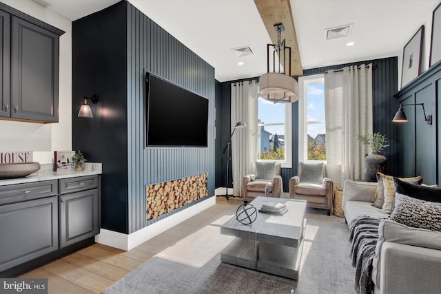 living room with light wood-style flooring and visible vents