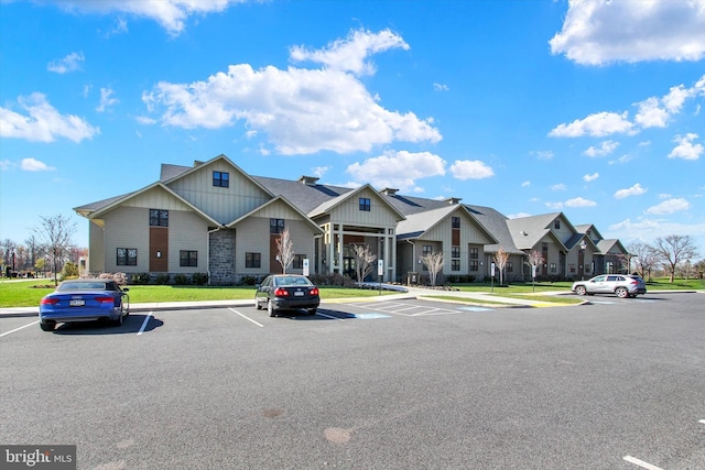 view of front of property with a front lawn, a residential view, and uncovered parking