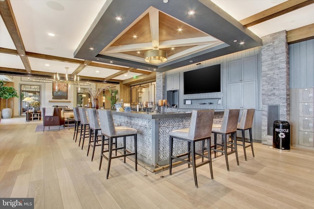 bar with beamed ceiling, coffered ceiling, and light wood-style floors