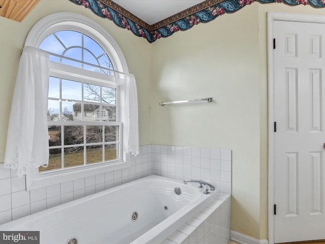 bathroom with a tub with jets