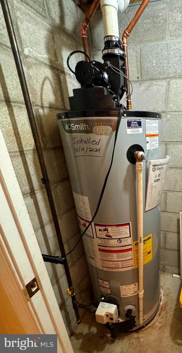 utility room featuring gas water heater