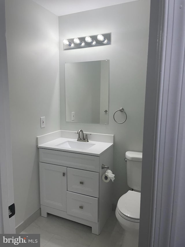 15712 Brandywine Rd, Dumfries, VA 22025 - half bathroom featuring vanity, toilet, baseboards, and marble finish floors