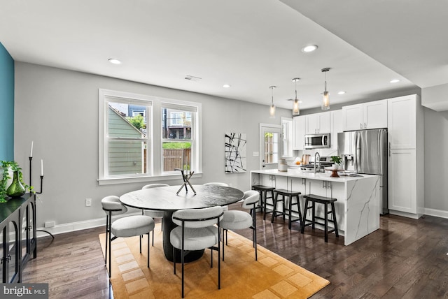 dining space featuring dark wood-style flooring, recessed lighting, baseboards, and visible vents