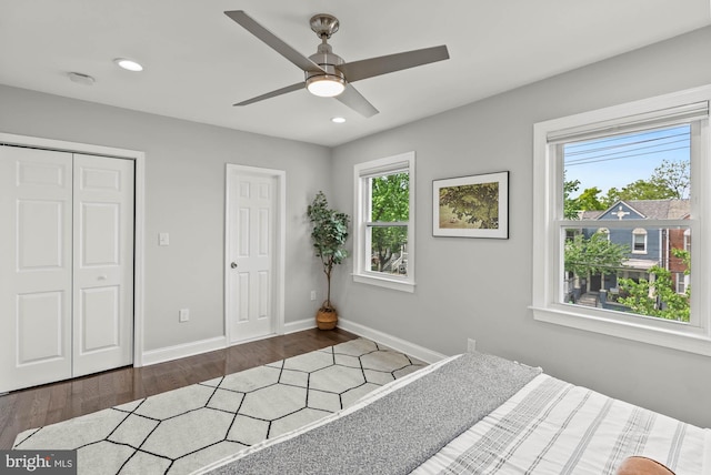 bedroom with recessed lighting, baseboards, multiple windows, and wood finished floors