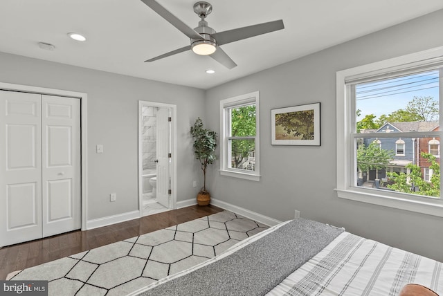 bedroom featuring baseboards, recessed lighting, wood finished floors, and multiple windows