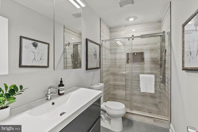 full bathroom featuring tile patterned flooring, vanity, toilet, and a shower stall