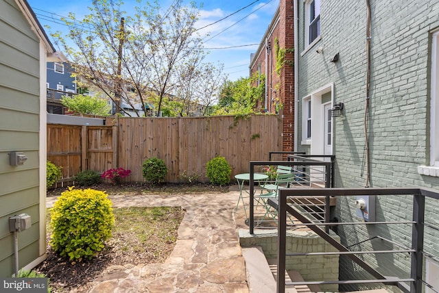 view of yard featuring fence and a patio