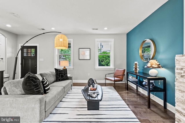living room with recessed lighting, baseboards, and wood finished floors