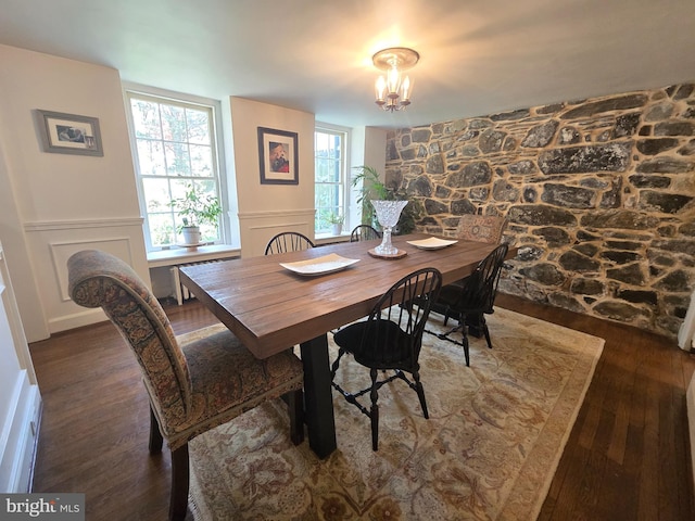 2531 Pickwick Rd, Baltimore, MD 21207 - dining room featuring hardwood / wood-style flooring, a chandelier, a wainscoted wall, and a decorative wall