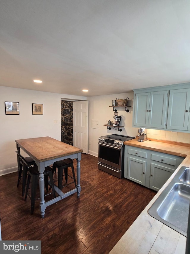 2531 Pickwick Rd, Baltimore, MD 21207 - kitchen with wood counters, a sink, electric stove, and dark wood finished floors