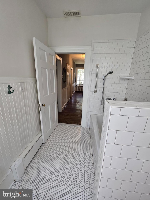 2531 Pickwick Rd, Baltimore, MD 21207 - full bathroom with a wainscoted wall, a tile shower, visible vents, tile patterned flooring, and a tub